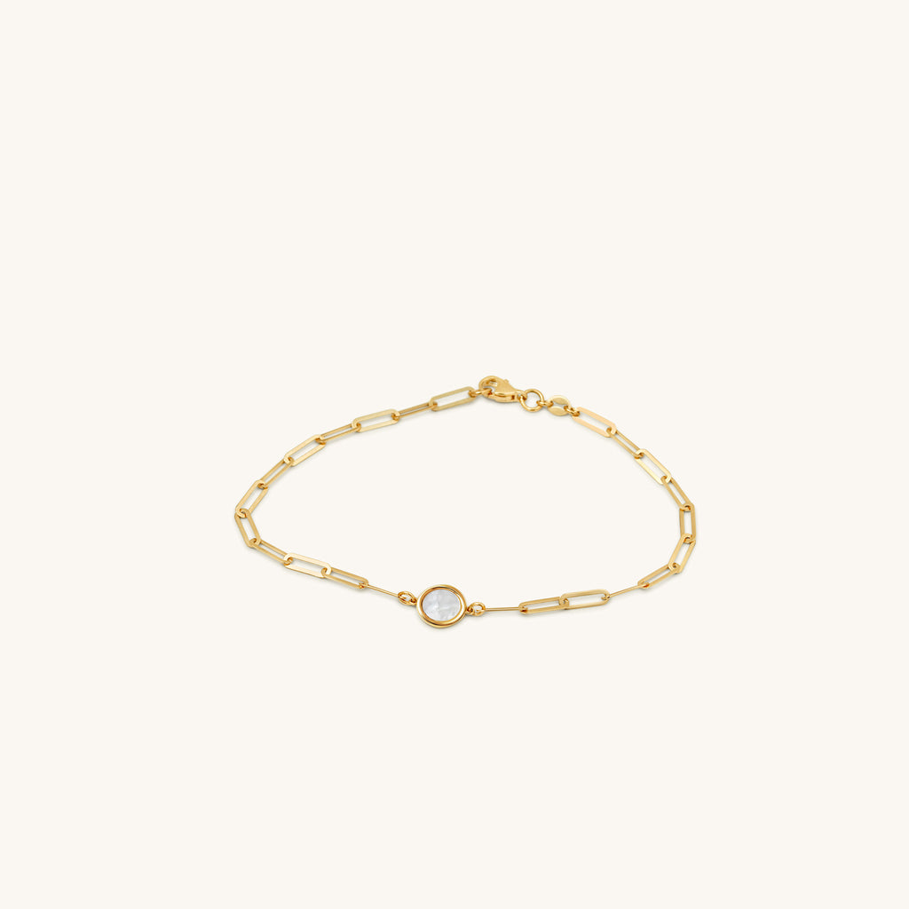 Angled view of 18K gold rectangular link bracelet featuring a moon-inspired mother-of-pearl motif