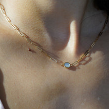Load image into Gallery viewer, 18K gold chain necklace with round mother-of-pearl pendant worn on a woman’s neck