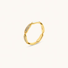 Load image into Gallery viewer, A gold ring with diamond facets and white enamel detailing, displayed against a white background