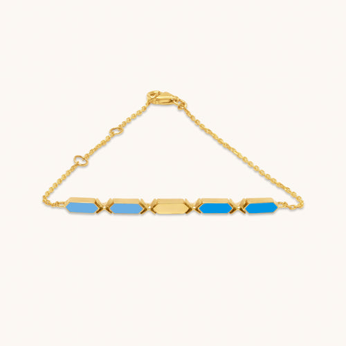 An 18k gold bracelet with two-tone blue facets, displayed against a white background.