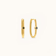 Load image into Gallery viewer, Front view of sleek 18K yellow gold hoop earrings featuring treated black natural diamonds set at the center