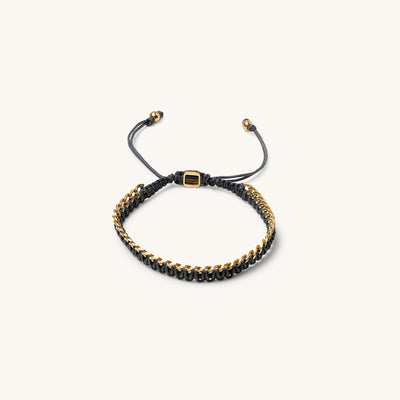 An 18k gold bracelet for women with intertwined grey threads, featuring a fully adjustable design.