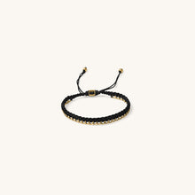 Load image into Gallery viewer, An 18k gold bracelet for women with black threads, featuring an adjustable sliding knot closure placed in a white background
