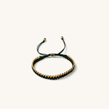 Load image into Gallery viewer, An 18k gold bracelet for women with black threads, featuring an adjustable sliding knot closure.