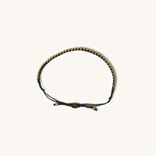Load image into Gallery viewer, A top view of 18k gold bracelet for women with black threads, featuring an adjustable sliding knot closure