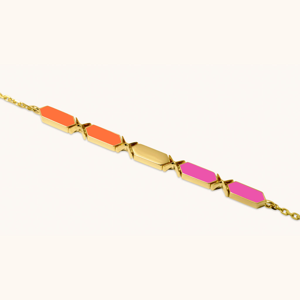 Close-up of Joubijoux Facets Fusion gold bracelet showing orange and pink enamel bars