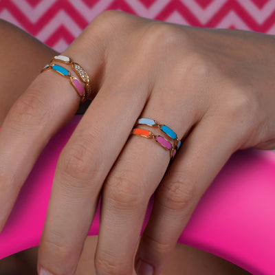 Joubijoux Facets Fusion gold ring worn on hand showing orange and pink enamel design