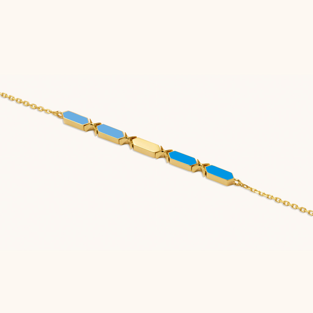 Close-up view  of Joubijoux Facets Fusion gold bracelet showing enamel bar craftsmanship