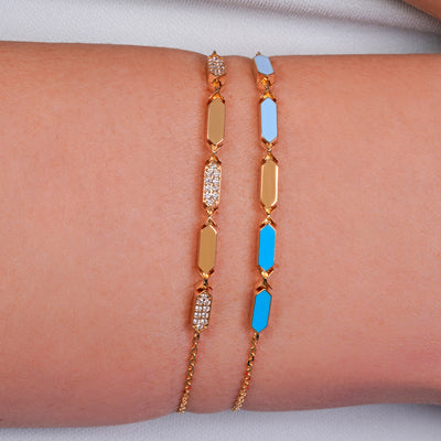 Joubijoux Facets Fusion gold bracelet worn on the wrist with blue enamel bar detailing