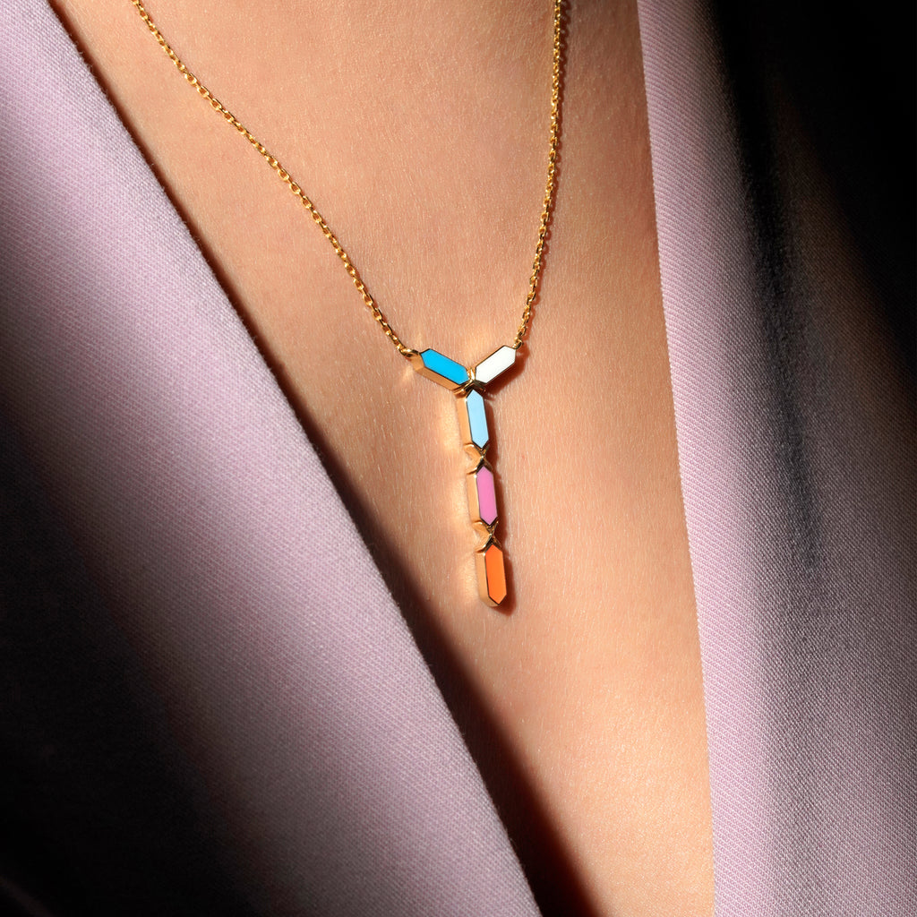 Worn view of Joubijoux Facets Jazzy 18K gold necklace showing multicolor enamel geometric pendant on neckline