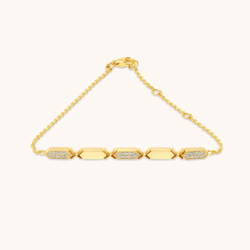 A diamond bracelet with gold chain and diamond segments, featuring a series of diamond pendants aligned in a row.