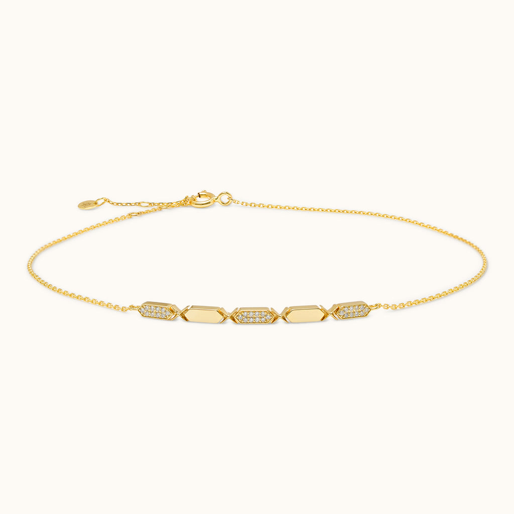A gold choker necklace with diamond segments, featuring a sliding clasp.