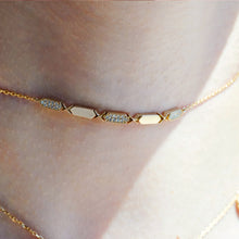 Load image into Gallery viewer, a women wearing  A gold choker necklace with diamond segments, featuring a sliding clasp.