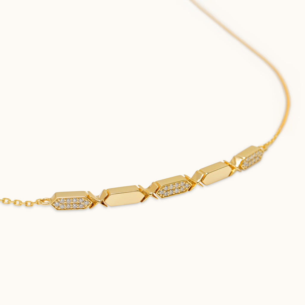 A joubijoux's gold choker necklace with diamond segments, featuring a sliding clasp.