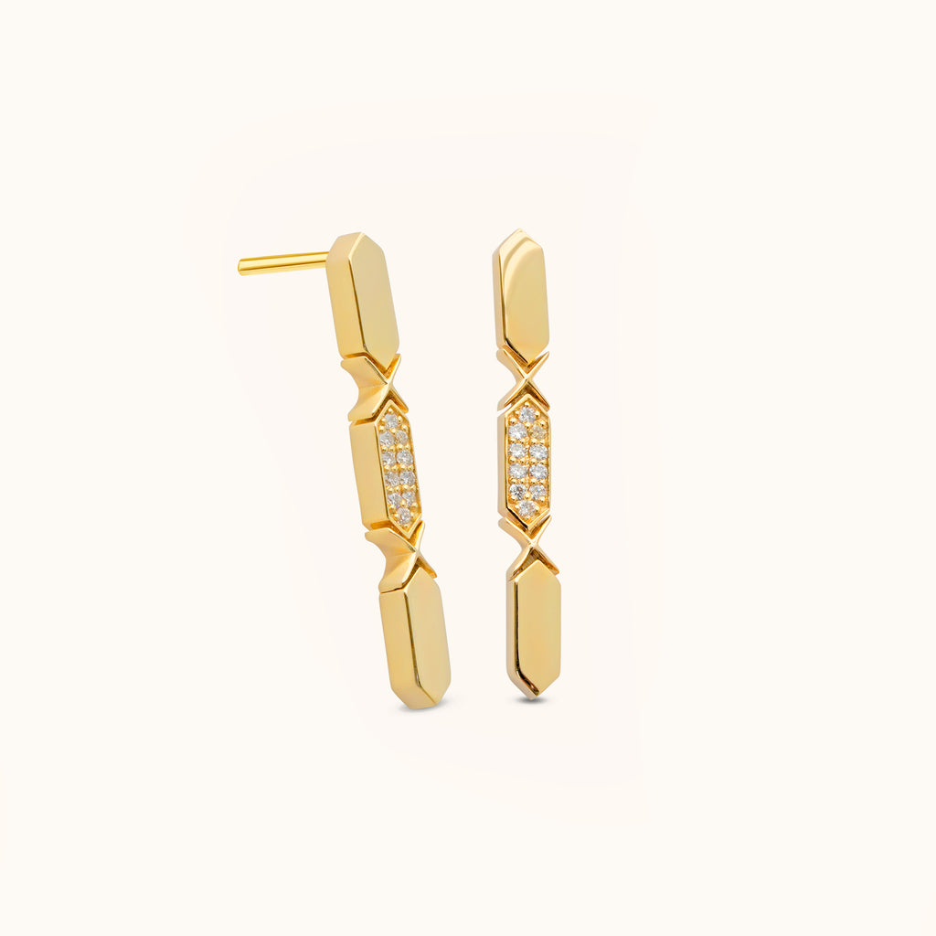 A pair of 18k gold diamond drop earrings with multiple diamond pieces aligned in a vertical line.
