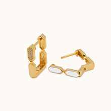 Load image into Gallery viewer, A pair of 18k gold, diamond hoop earrings with a combination of natural diamond and white enamel accents in a whtie background
