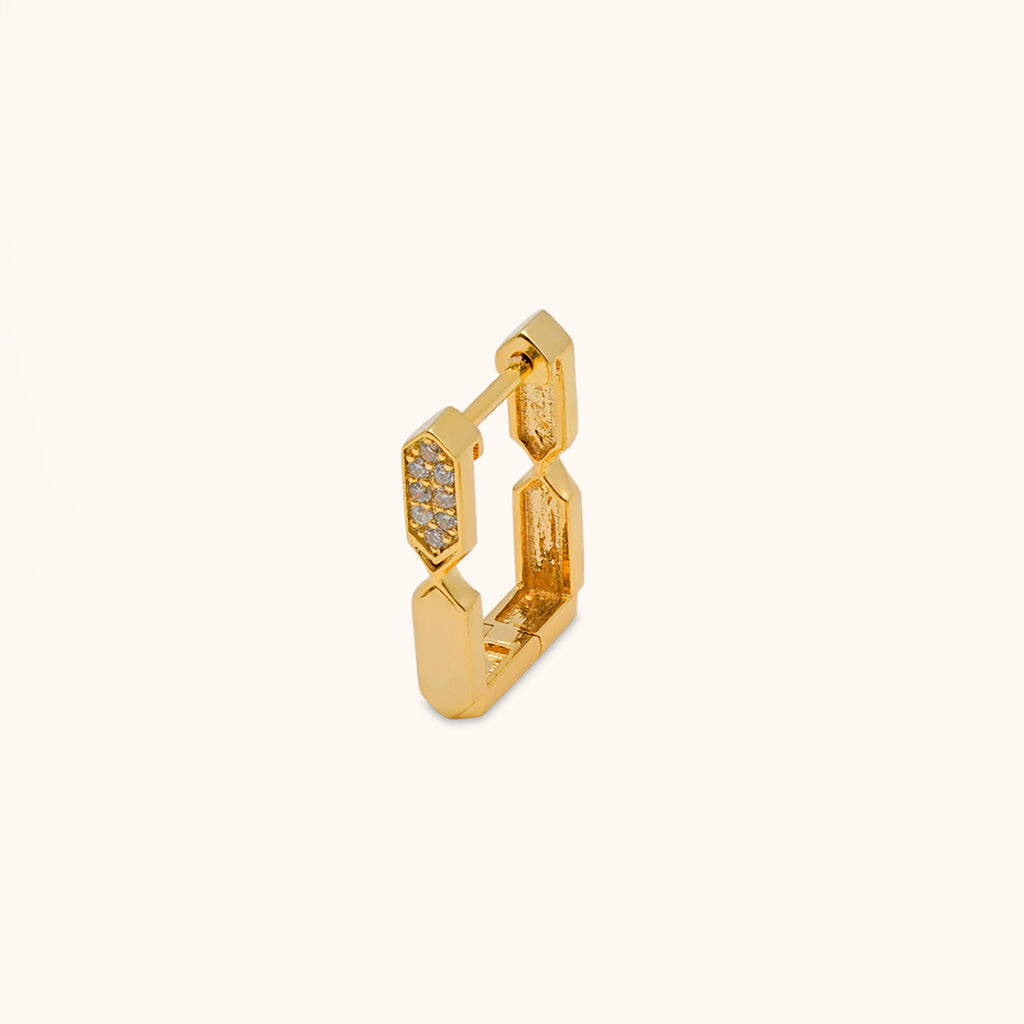 Gold and diamond hoop earring with embedded stones on a white background
