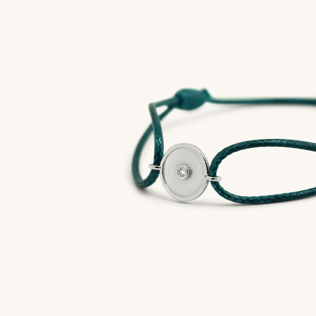 Close-up of Joubijoux gold bracelet highlighting 18K white gold Kaleido barrel centerpiece with single VS diamond