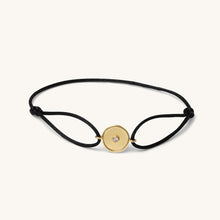 Load image into Gallery viewer, 18K yellow gold bracelet by Joubijoux with barrel-inspired center design and single diamond on adjustable black thread