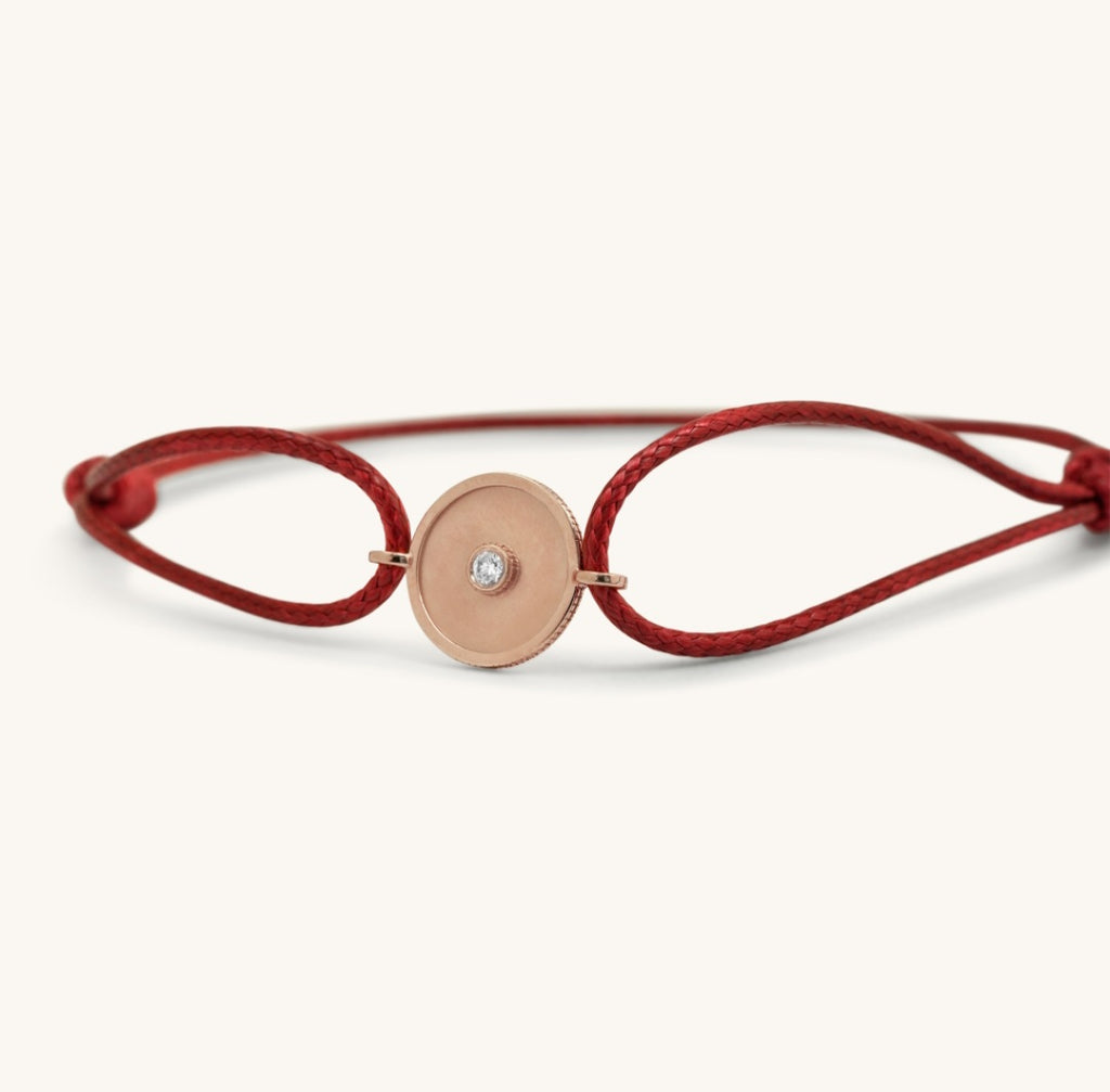 Close-up of Joubijoux gold bracelet for women highlighting 18K rose gold barrel centerpiece with single VS diamond