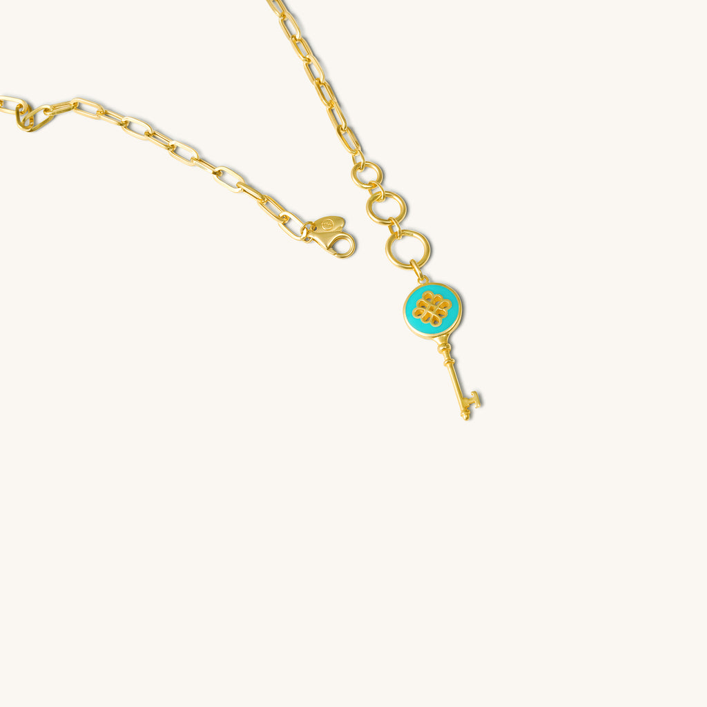 Clasp and adjustable loop detail of 18K gold green enamel key charm bracelet