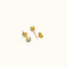Load image into Gallery viewer, Angled view of Joubijoux gold earrings showing 18K yellow gold stud posts and polished mother of pearl setting