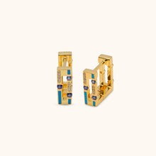Load image into Gallery viewer, Angled view of Joubijoux gold hoop earrings showing diamond side and blue sapphire enamel side