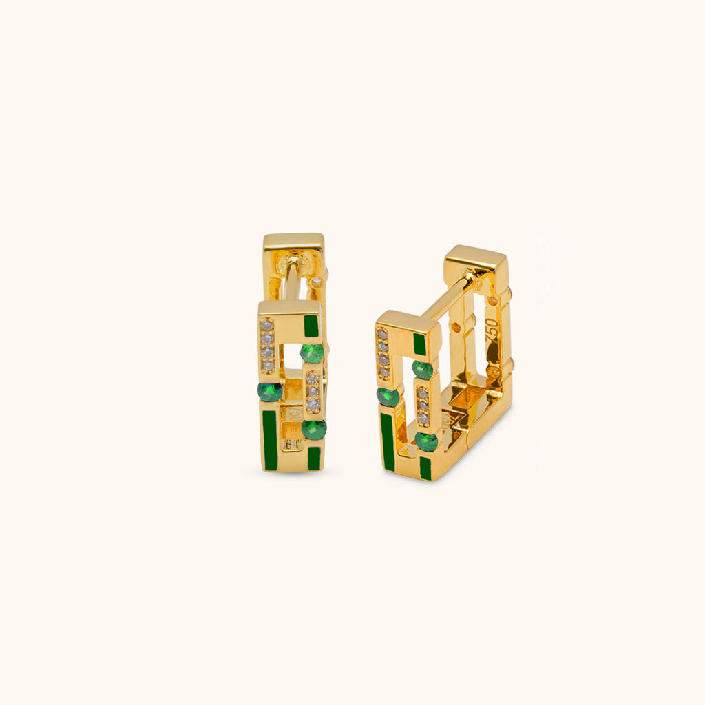 Angled view of Joubijoux gold hoop earrings showing diamond side and emerald stones set in green enamel