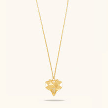 Load image into Gallery viewer, Front view of Joubijoux gold necklace design featuring 18K heart-shaped pendant with white enamel and VS diamonds