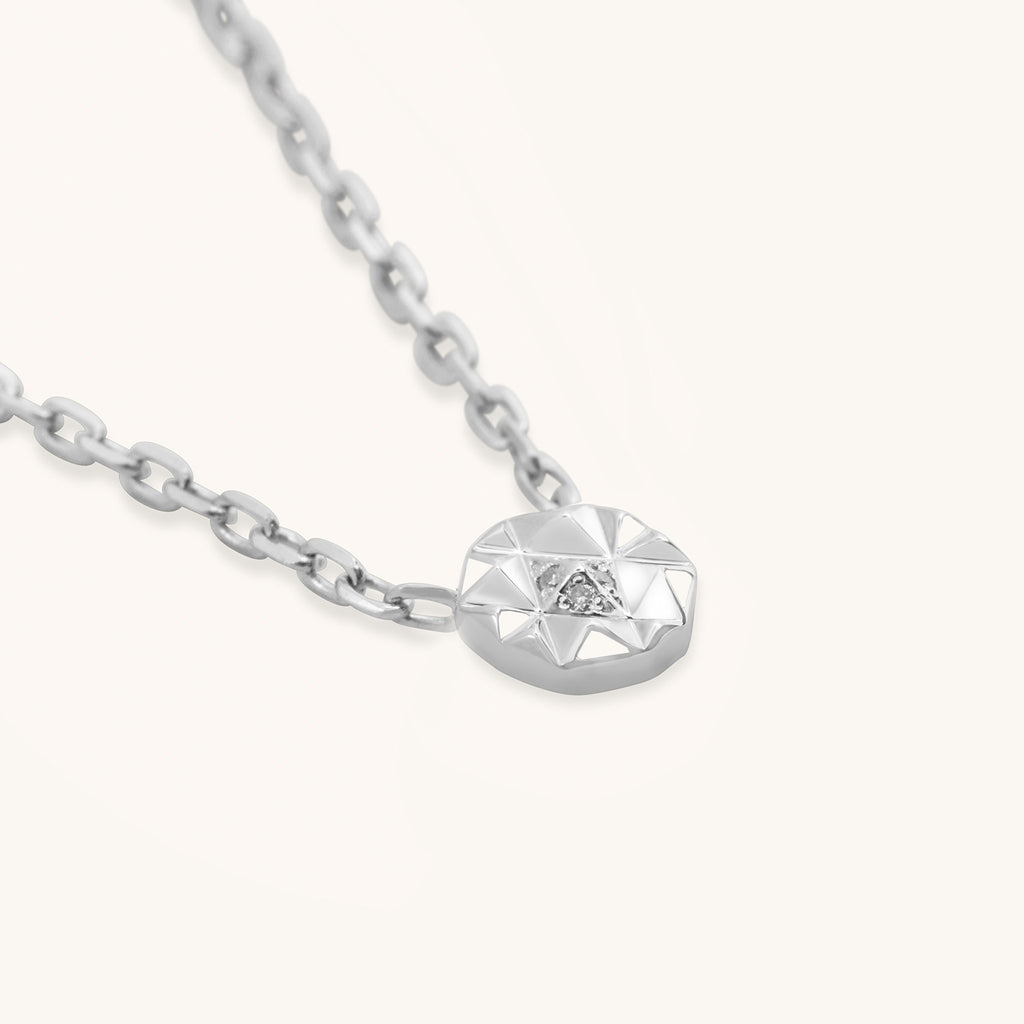 Close-up of Joubijoux gold necklace design highlighting geometric Slopes Mini pendant with four VS diamonds