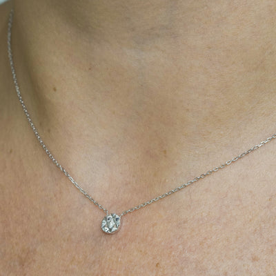 Worn view of Joubijoux gold necklace design showing Slopes Mini pendant layered elegantly on the neckline
