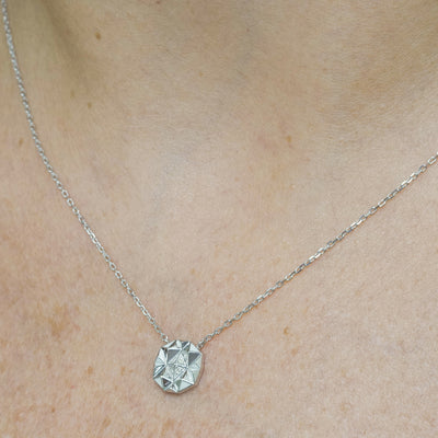Worn view of Joubijoux gold necklace design showing Slopes Small pendant resting elegantly on the neckline