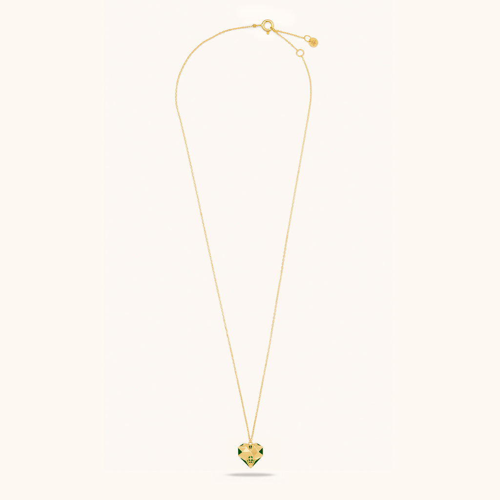 Flat lay view of Joubijoux gold necklaces for women showing full 18K gold chain with heart-shaped emerald pendant