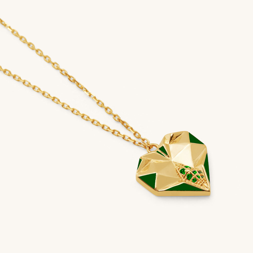 Close-up of Joubijoux gold necklaces for women highlighting faceted heart design green enamel and six emerald stones