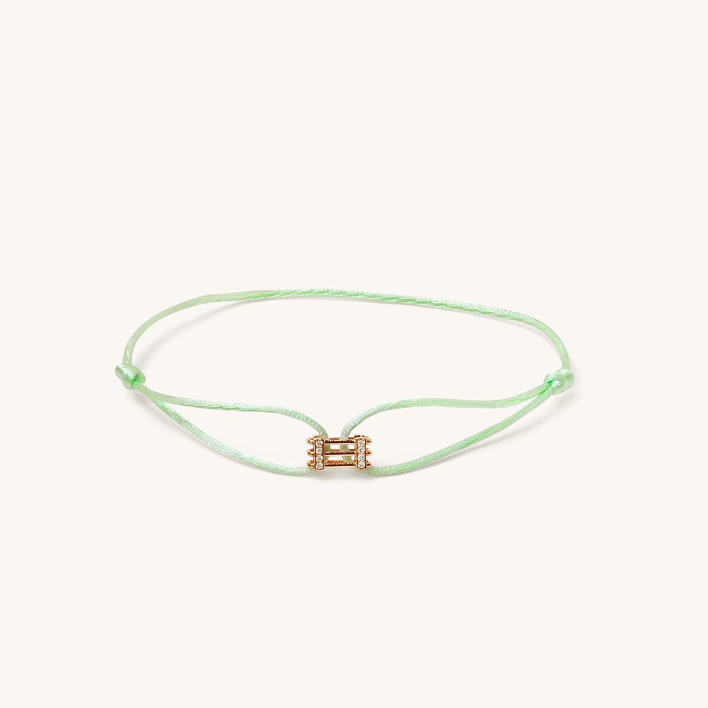 Front view of Kaleido Triad rose gold bracelet with pistachio green adjustable cord and diamond accents