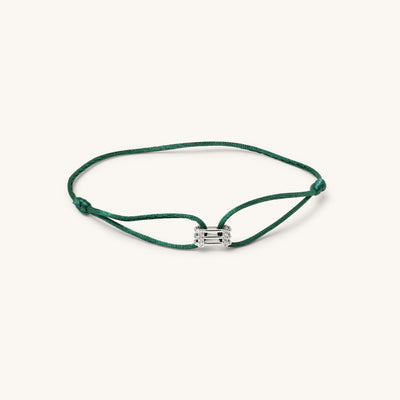 Front view of 18K white gold Kaleido Triad bracelet with VS diamonds and adjustable green thread