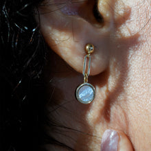 Load image into Gallery viewer, Close-up of woman wearing 18K gold mother-of-pearl drop earrings showing elegant dangling circular design