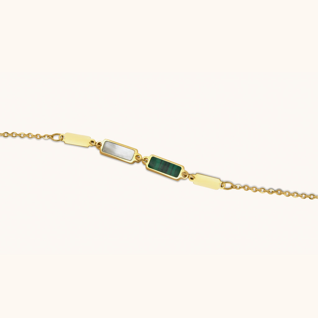 Close-up of 18K gold bracelet showcasing malachite stone and mother-of-pearl inlay with polished gold links