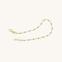 Load image into Gallery viewer, Full length view of 18K gold bracelet with green enamel raindrop accents and adjustable chain