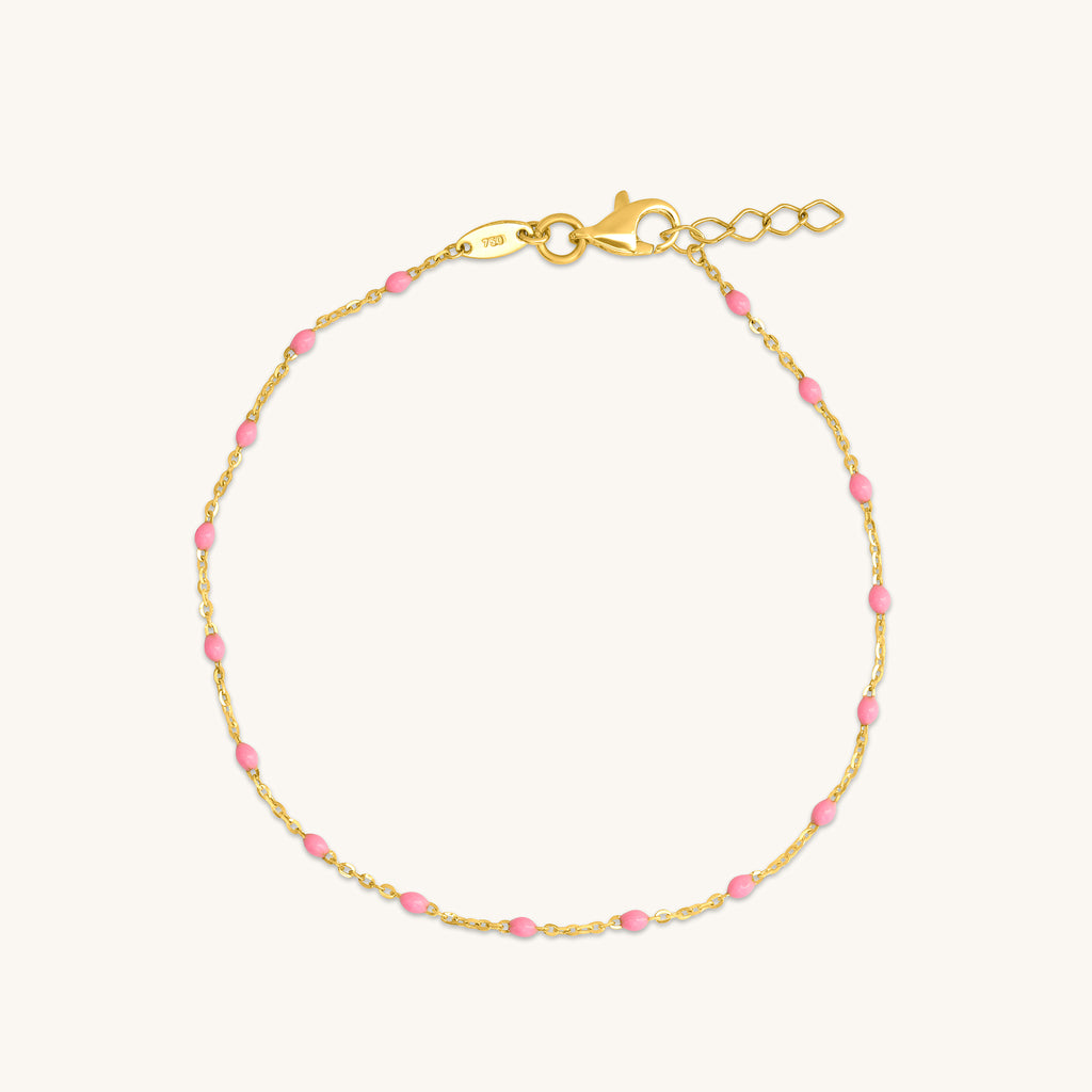 18K gold raindrop bracelet with pink enamel accents in a delicate chain design