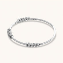 Load image into Gallery viewer, Angled view of white gold diamond bangle featuring screw motif accents