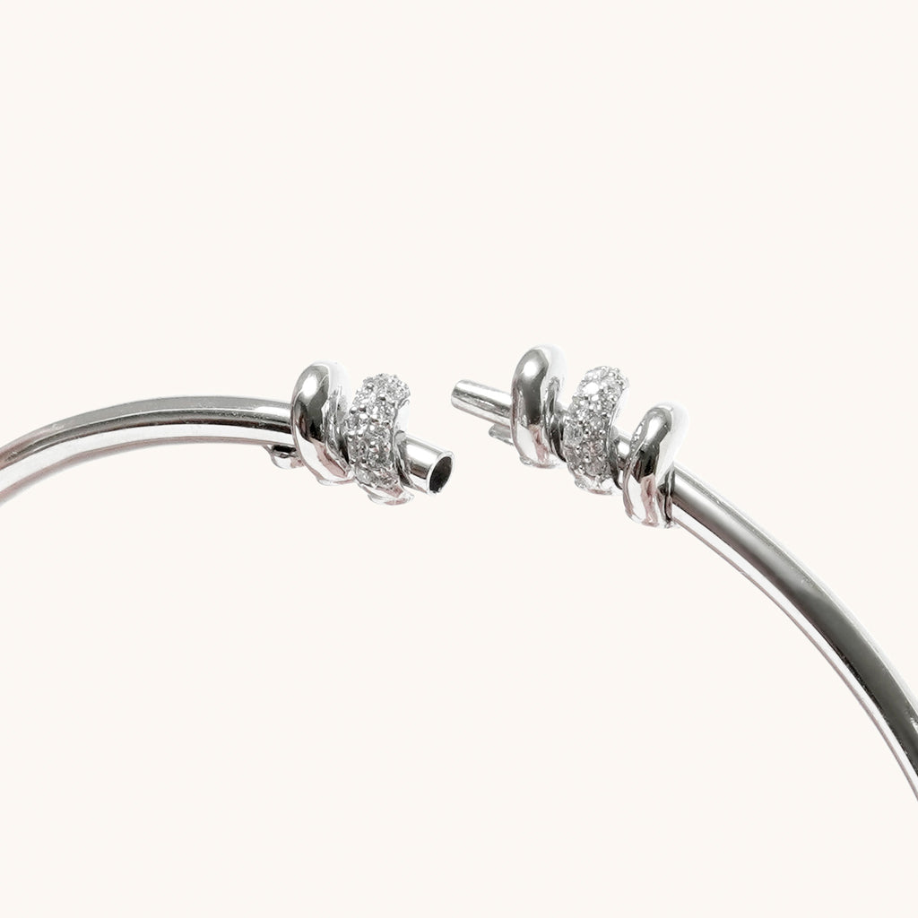 Close-up of screw-style opening mechanism on white gold diamond bangle