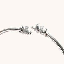 Load image into Gallery viewer, Close-up of screw-style opening mechanism on white gold diamond bangle