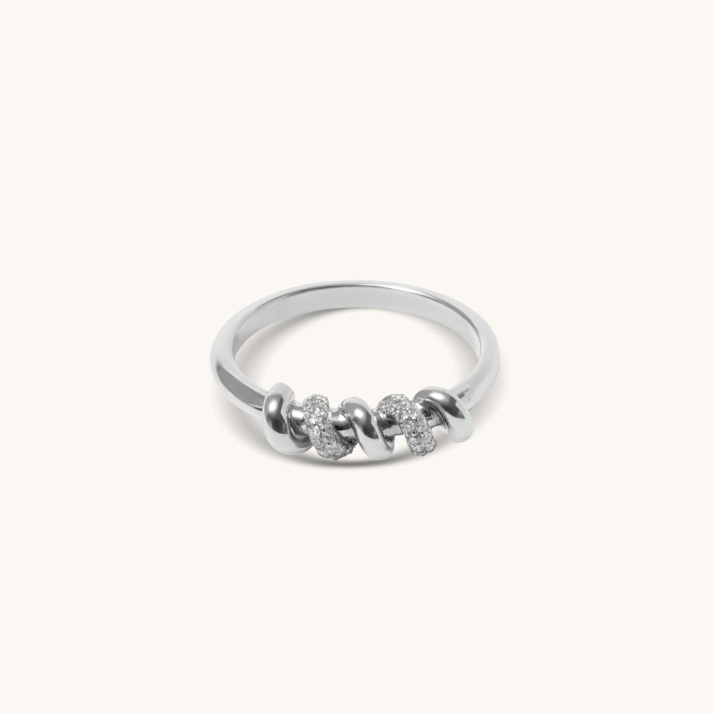 Top view of white gold screw motif ring with pavé diamonds