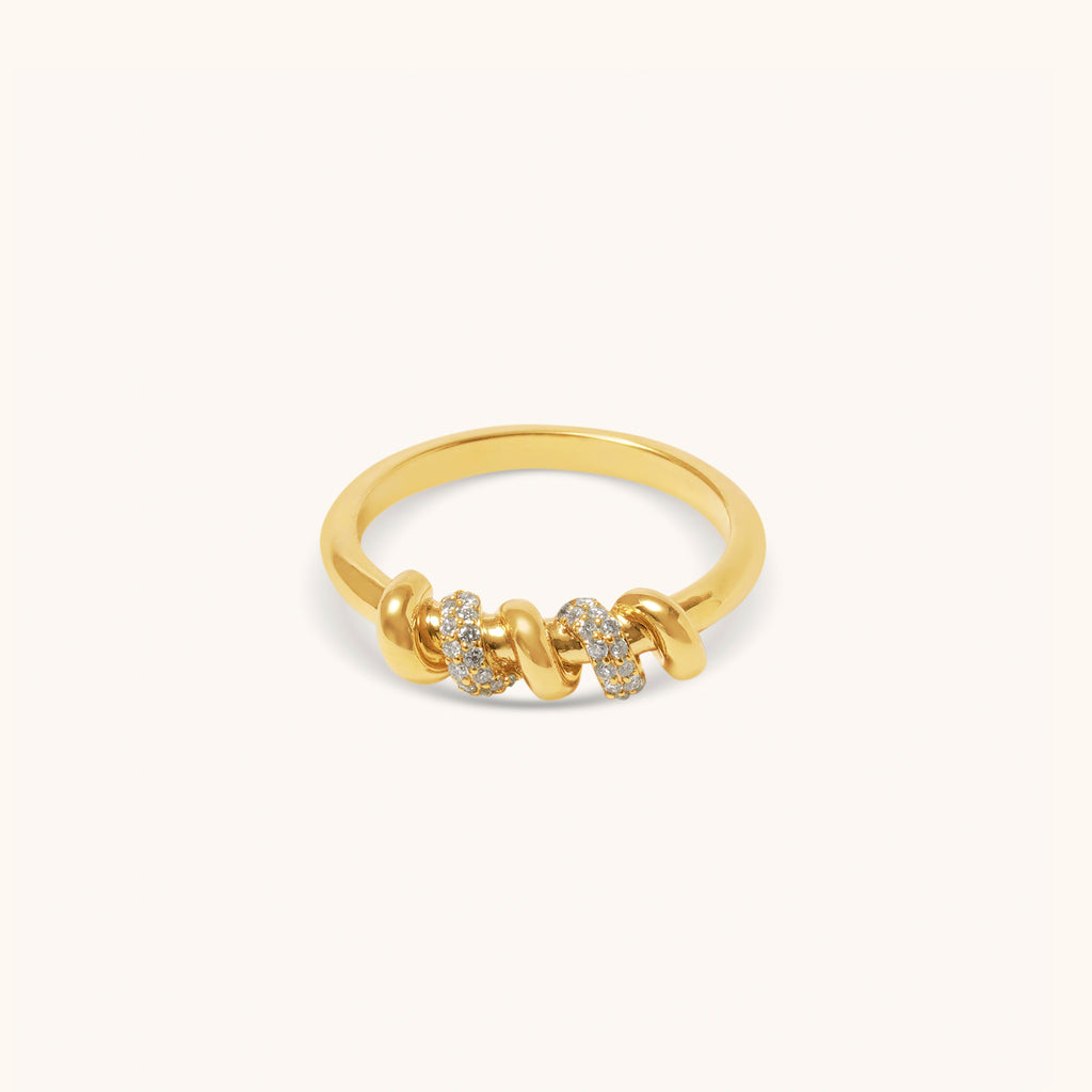 Top view of yellow gold screw motif ring with pavé diamonds