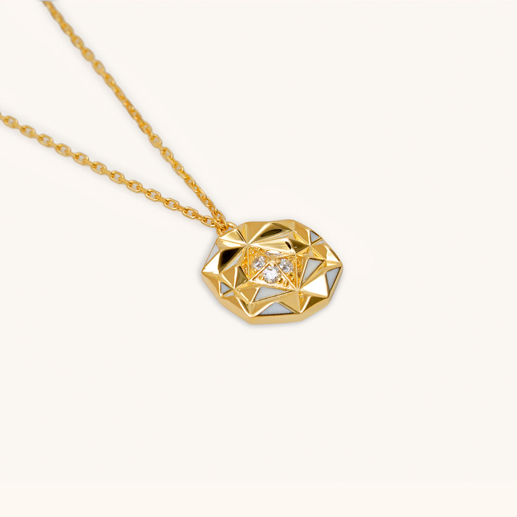 Close-up of slopes diamond necklace pendant with VS diamonds and geometric gold design