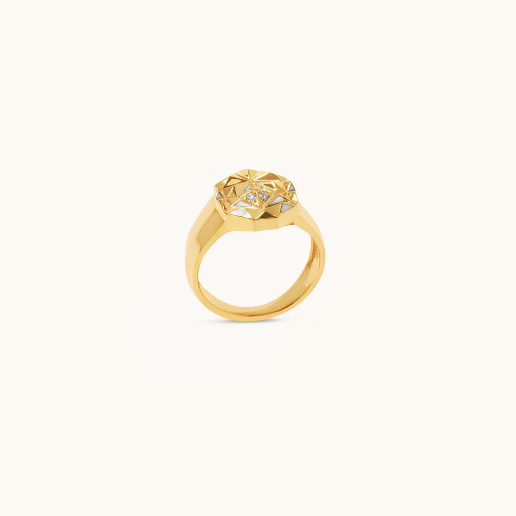 Side angle view of Slopes pinky diamond ring in 18K gold with white enamel