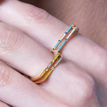 Load image into Gallery viewer, Versa 18K gold ring worn on finger with blue sapphire stones, diamonds, and enamel accents