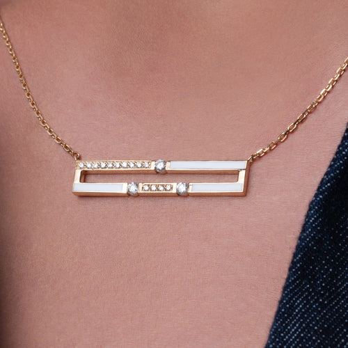 Close-up view of Versa Diamond Double Line gold necklace design worn on neck, highlighting diamond pendant in 18K yellow gold with white enamel