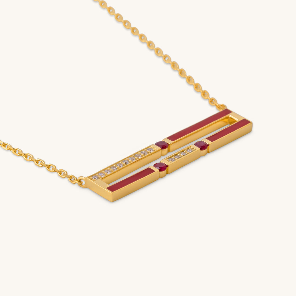 Close-up of Versa diamond and ruby pendant with enamel detailing in 18K gold